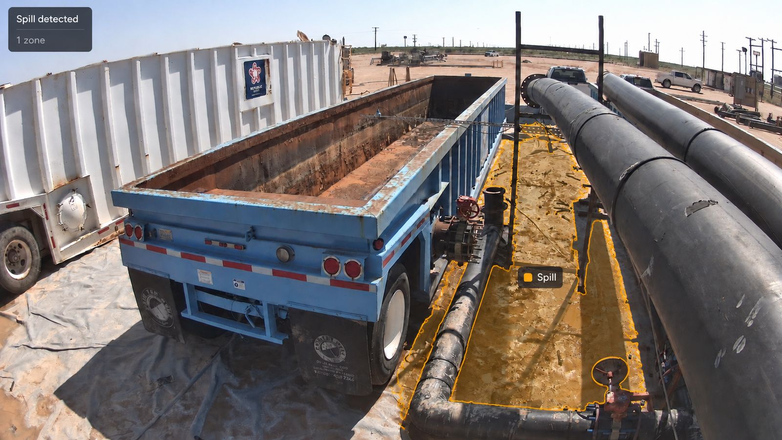 The same view with liquid on the containment outlined and flagged as a spill zone.