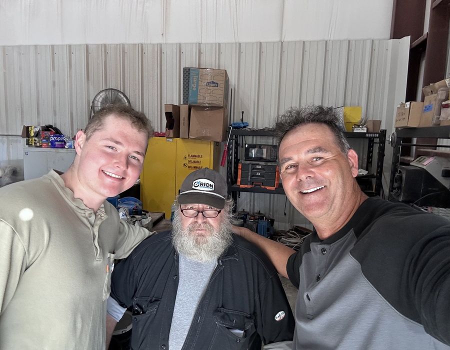 Ryan and Ivan with Jim at the equipment shop.